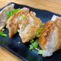 Pan - Fried Crab Pork Dumplings · Minced pork, lump crab meat onions, carrots, and cabbage wrapped in a wonton wrapper and ser...