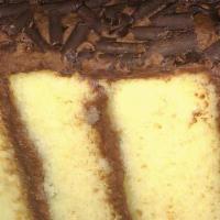 Golden Chocolate Cake · Our moist yellow cake layers smothered with chocolate buttercream frosting between the layer...