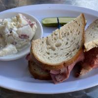 Corned Beef · Corned beef topped with swiss cheese and cole slaw. Served on grilled rye bread.