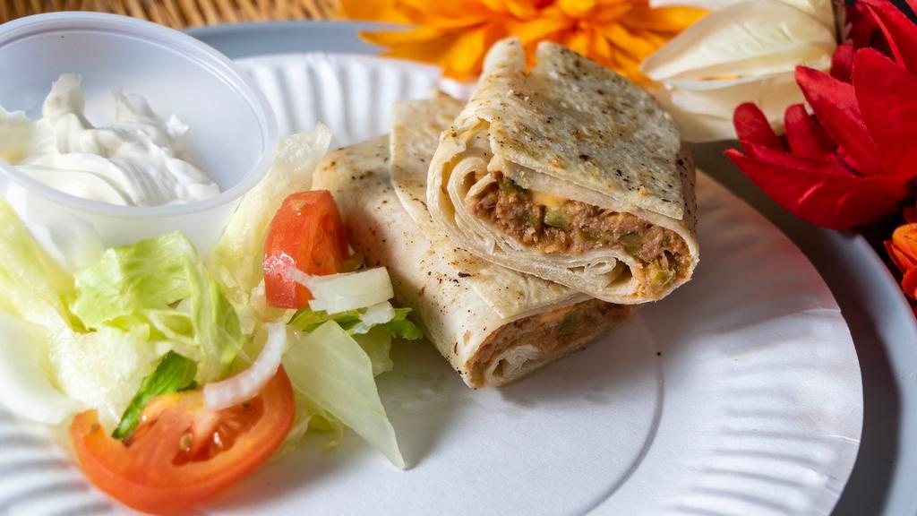 Beef And Cheese Burrito · Beef with green chiles and 3 slices of cheese in a hand-stretched tortilla. Serves two 7 oz burritos with side and a drink.
