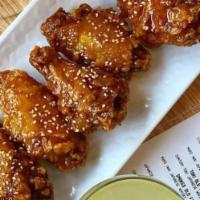 Domu Wings (6) · Gluten free. Six extra crispy wings coated with kimchi butter sauce and sesame seeds.