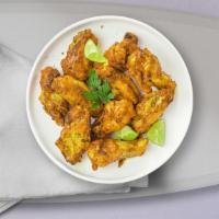 Sour Pepper Wings · Fresh chicken wings breaded, fried until golden brown, and tossed in lemon pepper sauce. Ser...