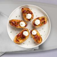 Potato Skins · Baked potato skins filled with cheddar cheese, crispy bacon, and sour cream.