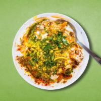Veggie Samosa Chaat  · Classic samosas, crushed and mixed with hot, sweet, and tangy sauces, yogurt, and topped wit...