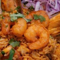 Arroz Con Mariscos · Our best seafood combination of shrimp, squid and scallops, all mixed with rice, red pepper,...