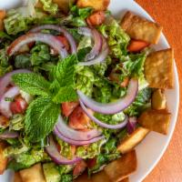 Fattoush · Lettuce, parsley, onions, tomato, cucumbers, sumac, and pomegranate dressing topped with fri...