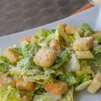 Caesar Salad · Crispy Romaine lettuce with croutons dressed with our own homemade dressing and Parmesan che...