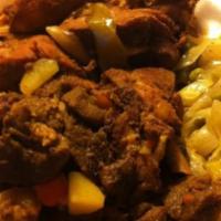Curried Goat · Goat meat cooked in curry and other island spices.