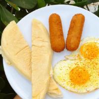 Dos Croquetas + Eggs + Tostada · Dos Croquetas paired with scrambled or sunny side up eggs and buttery cuban toast.<br />