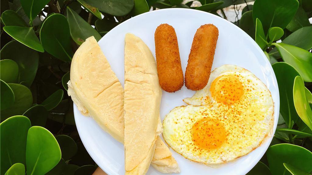 Dos Croquetas + Eggs + Tostada · Dos Croquetas paired with scrambled or sunny side up eggs and buttery cuban toast.<br />