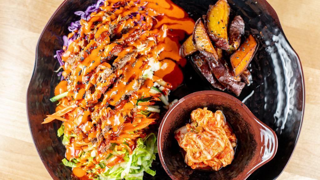 Beef Bibimbap · Grilled beef marinated in soy sauce. Steamed rice, carrot, cucumber, lettuce, purple cabbage, and cabbage with black sesame on top. Served with your choice of two sides and blossom tree sauce (spicy, mild or sweet soy).