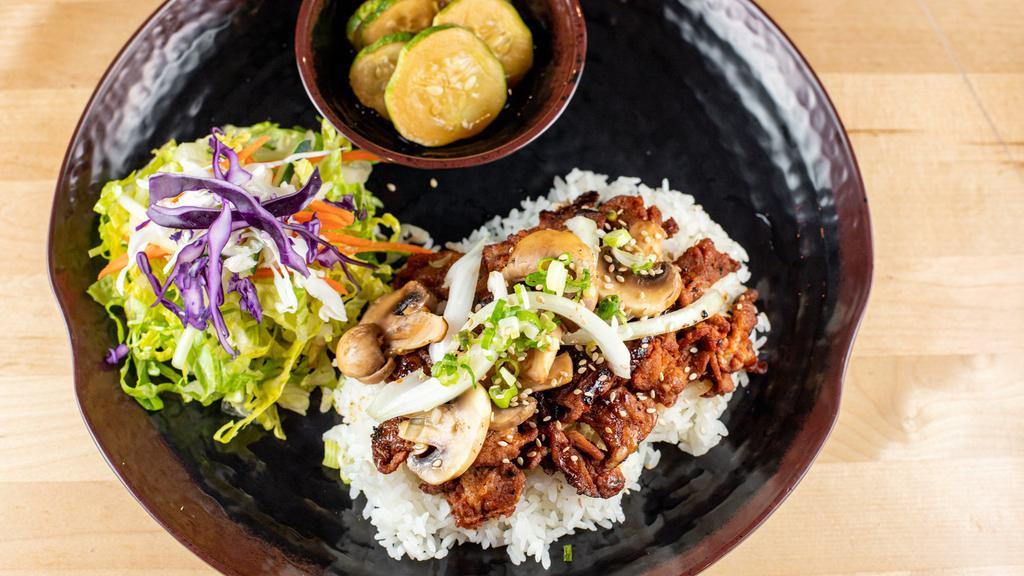 Pork Bullgogi Rice · Stir-fried pork marinated in chili paste with onion, mushroom, green onion, and sesame. Served with steamed rice with your choice of two sides.