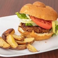 Beyond Burger · Grilled vidalia onions, lettuce, and tomato on a home-baked roll, served with turmeric wedges.