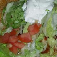 Burrito Supreme · A flour tortilla stuffed with beef and beans, topped with cheese, lettuce, tomato and sour c...