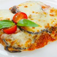 Melanzane Parmigiana · Crispy eggplant pomodoro sauce with parmesan, mozzarella and basil pesto.