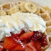 Fresh Waffle · With strawberries, banana, lightly powdered sugar on top, whipped cream & syrup
