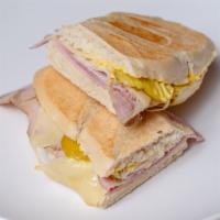 Cuban Sandwich · Ham, pork, Swiss cheese, pickles, mayo, and mustard in a baguette bread.