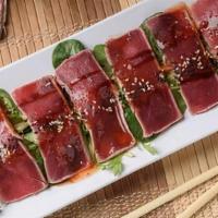 Tuna Tataki · Red tuna lightly seared, sliced, drizzled with sweet chili, ponzu and eel sauces and finishe...