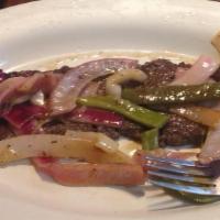 Churrasco · Skirt steak with onions and peppers.