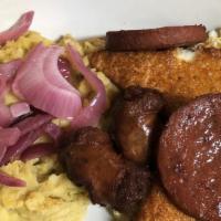 Mangu · Boiled mashed green plantain with cooked vinegar red onions on top.