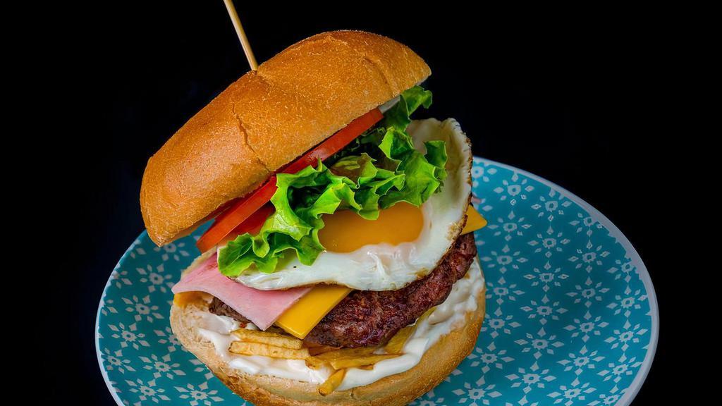 La Venezolana Burger · Black Angus Beef pattie, ham, cheese, lettuce, tomato, egg, potato sticks, and specialty sauces.