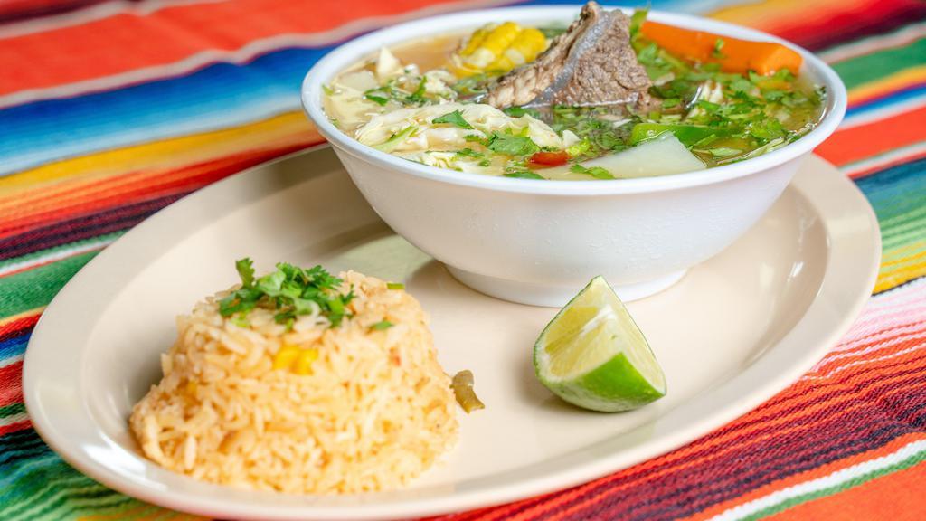 Caldo De Res · Mexican style beef soup with vegetables and a side of rice.
