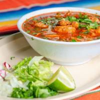 Pozole · Red pork soup with hominy & a slide of cabbage onions cilantro & lime.