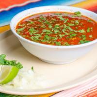 Menudo · Mexican style beef tripe soup with hominy & a side of onion cilantro & lime.
