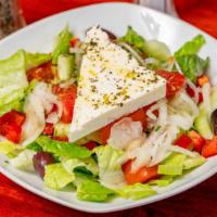 Greek Salad · Tomatoes, cucumbers, olives, bell peppers, onions, feta cheese, and finished with EVOO lemon...