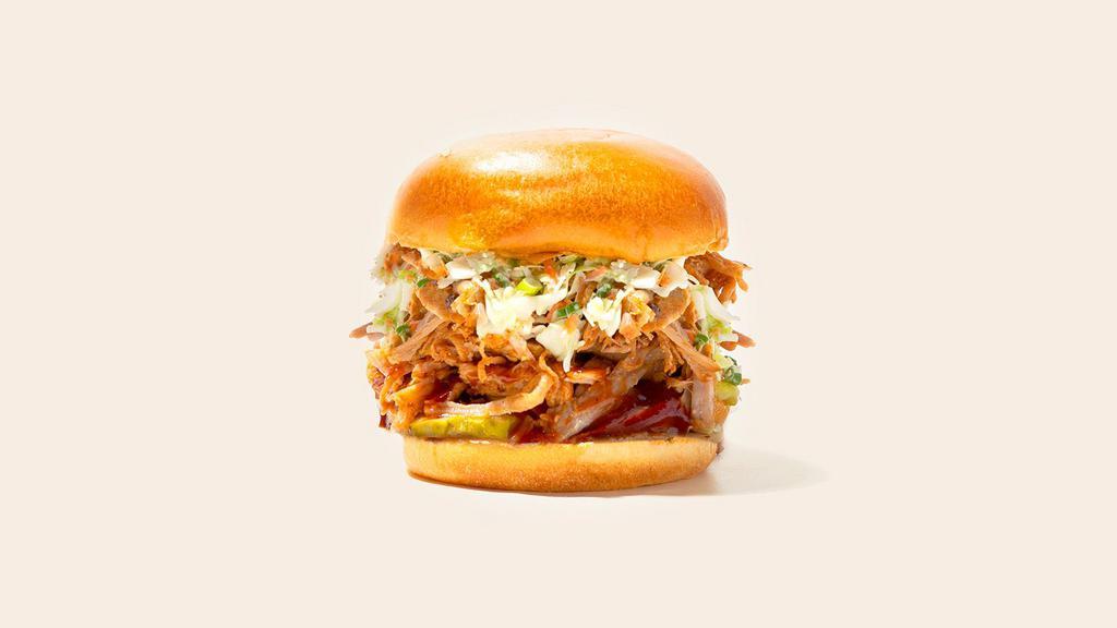 Bbq Pulled Pork Sandwich · Smoked pulled pork with coleslaw and bbq sauce on a fluffy bun.