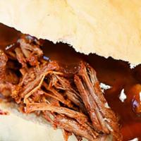 Bbq Pork And Brisket Sandwich · Smoked and chopped beef brisket and pulled pork with coleslaw and bbq sauce on a fluffy bun.