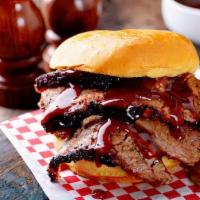 Bbq Sausage And Pork Sandwich · Smoked sausage and pulled pork with coleslaw and bbq sauce on a fluffy bun.