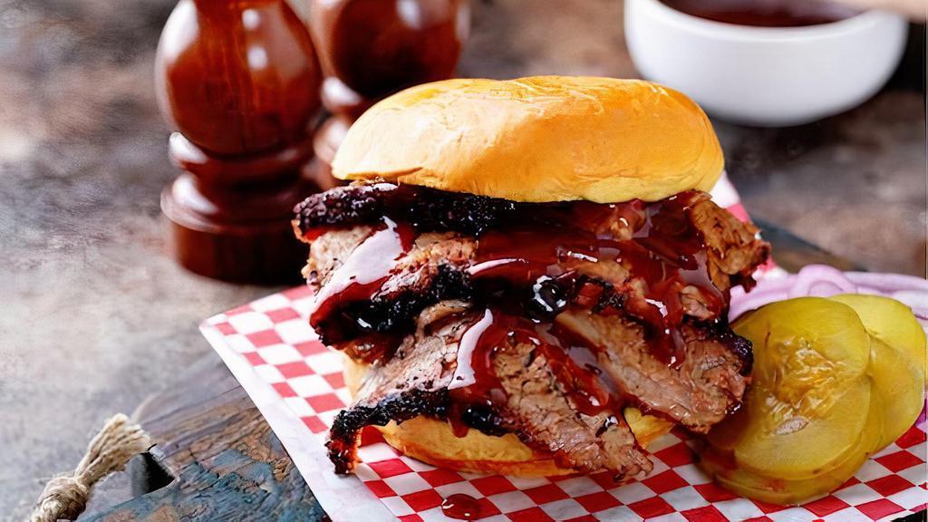 Bbq Sausage And Pork Sandwich · Smoked sausage and pulled pork with coleslaw and bbq sauce on a fluffy bun.