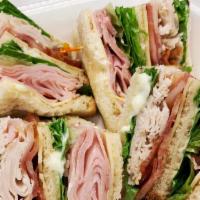 Three Decker Club · Roasted turkey, ham and swiss cheese bacon, lettuce, tomato and mayo on choice of bread.