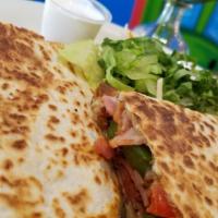 Alambre Quesadilla · Flour tortilla filled with cheese, steak, grilled peppers, onions, bacon, ham. Served with R...