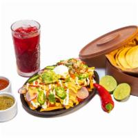  Chicken Nachos · Tortilla chips layered with melted Cheddar cheese, sour cream, guacamole, pico de gallo, jal...