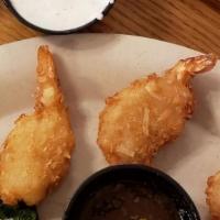Coconut Shrimp · Shrimp rolled in a light coconut breading and then fried. Served with a sweet and spicy sauce.