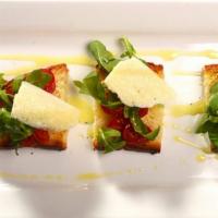 Bruschetta Arugula  · Grilled Bread rubbed with garlic, arugula, 
cherry tomatoes, parmesan cheese, and basil.