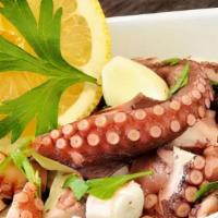 Octopus Salad · Grilled Octopus in a salad of arugula, tomato cherry, Red onion, olives, and vinaigrette.