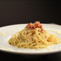 Spaghetti Carbonara · Spaghetti pasta with bacon, parmesan cheese, egg yolk, and black pepper.