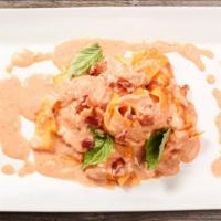 Pappardelle Amor Di Pasta · Pappardelle pasta with pink vodka sauce, mushroom bacon and speck.