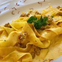 Pappardelle Sausage & Saffron · Pappardelle pasta with alfredo sauce, sausage, and saffron.