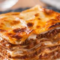 Lasagna Bolognese · Layers of egg pasta with bolognese sauce (tomato sauce with minced onion, pork, and beef) be...