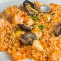 Risotto Seafood · Carnaroli rice with salmon, clams, squid, calamari, mussels, and shrimps.
