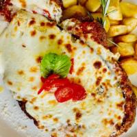 Milanese Parmigiana · Breaded chicken deep fried with tomato sauce, eggplant, and cheese melted on the top.