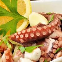 Octopus Salad · Grilled Octopus in a salad of arugula, tomato cherry, Red onion, olives, and vinaigrette.