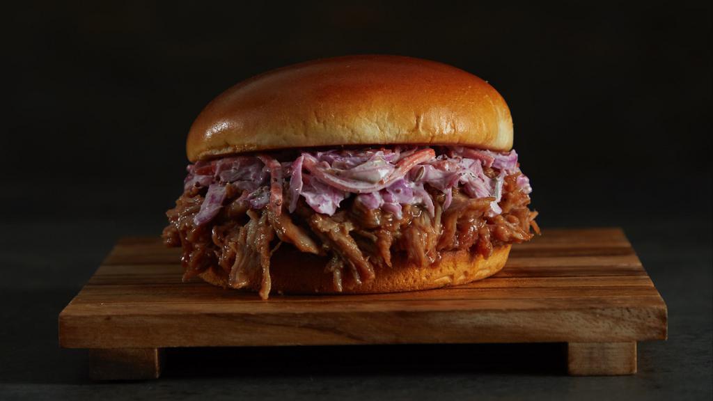 Pulled Pork Sandwich · Mouthwatering pulled pork served on a brioche bun with spicy coleslaw and sweet baby rays BBQ sauce on the side.
