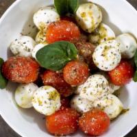 Caprese Salad · Mozzarella cheese, tomatoes, basil, olive oil & balsamic vinegar.