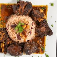 Oxtail · Served in a brown gravy with butter beans, rice and peas or jasmine rice and plantains.