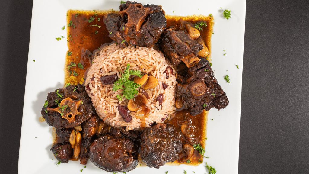 Oxtail · Served in a brown gravy with butter beans, rice and peas or jasmine rice and plantains.